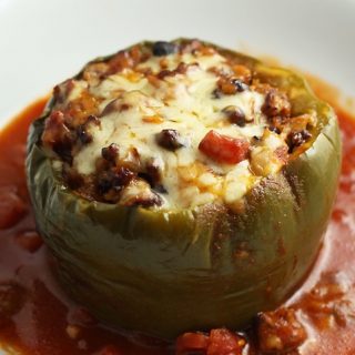 Green bell pepper stuffed with beef, tomatoes, beans, corn.