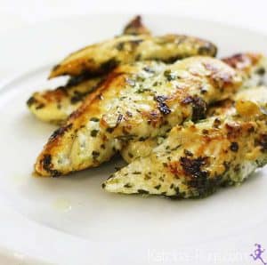 Grilled chicken breast strips on white plate