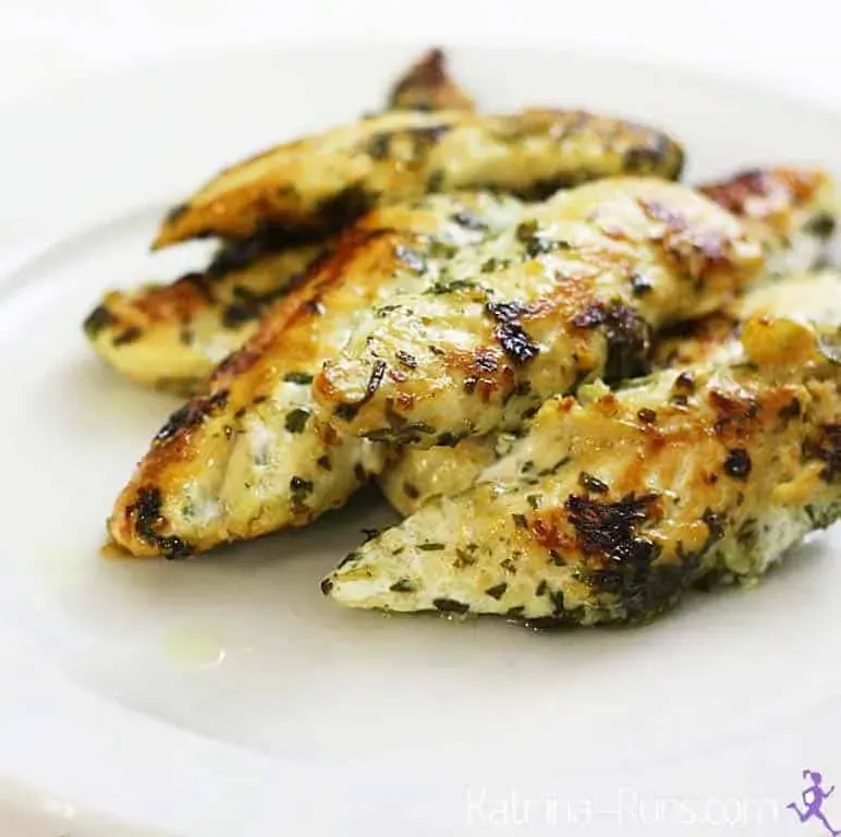 Grilled chicken breast strips on white plate