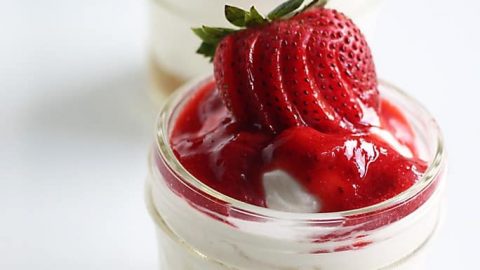 Gluten free strawberry cheesecake in individual serving jars.
